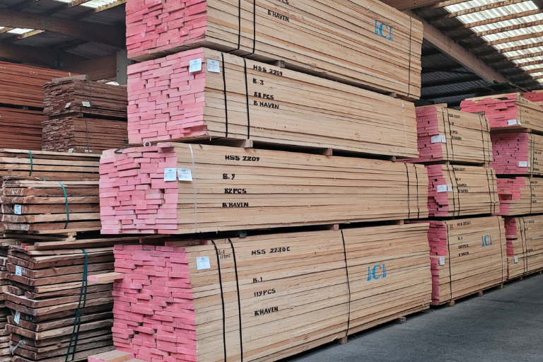 Exotic hardwood timber – meranti and iroko planks stacked in storage